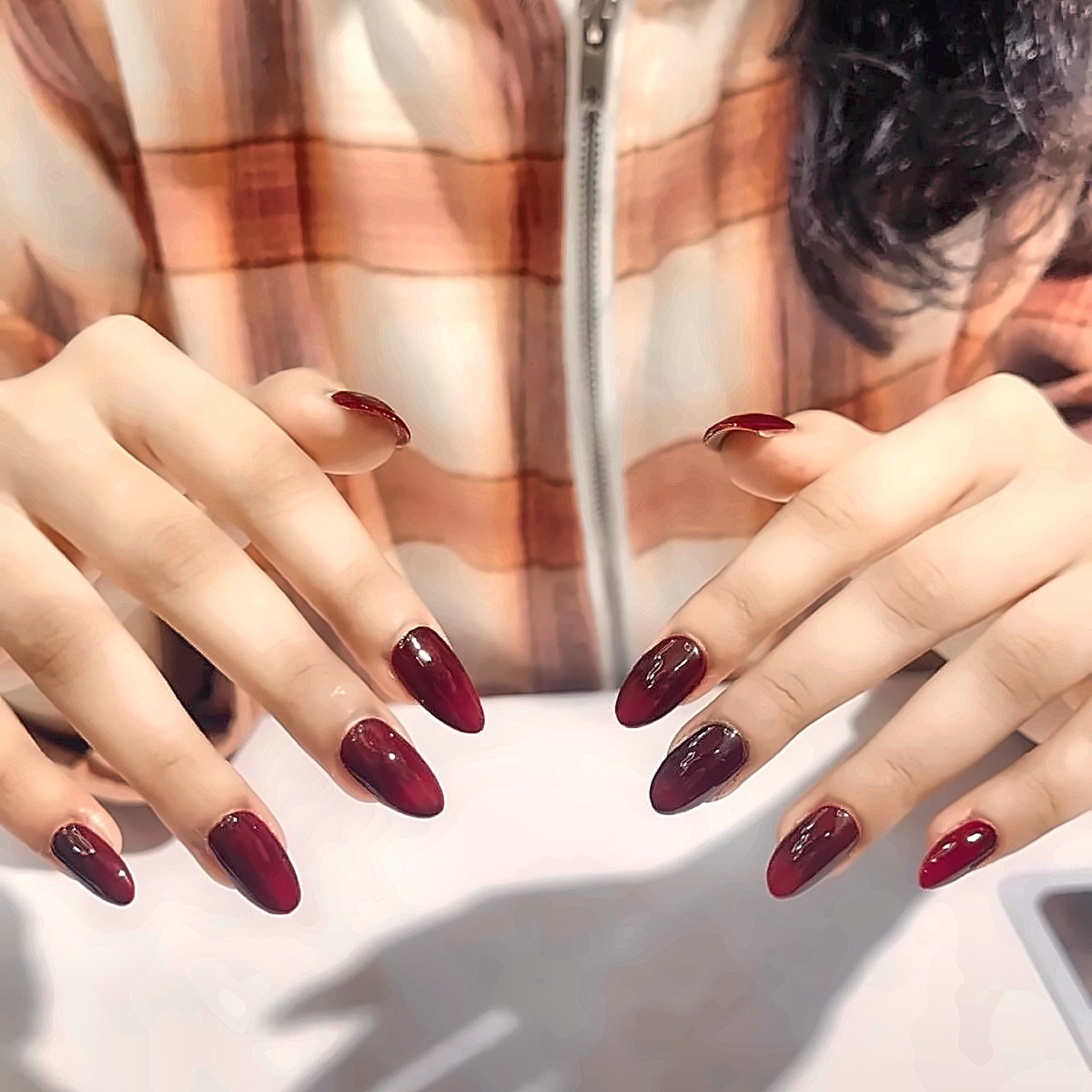 Deep wine-red gel manicure with a mirror-gloss finish