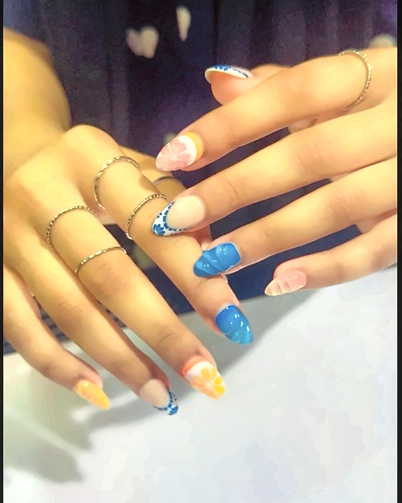 Freehand nail art set mixing colour blocks, lines and glitter across ten nails