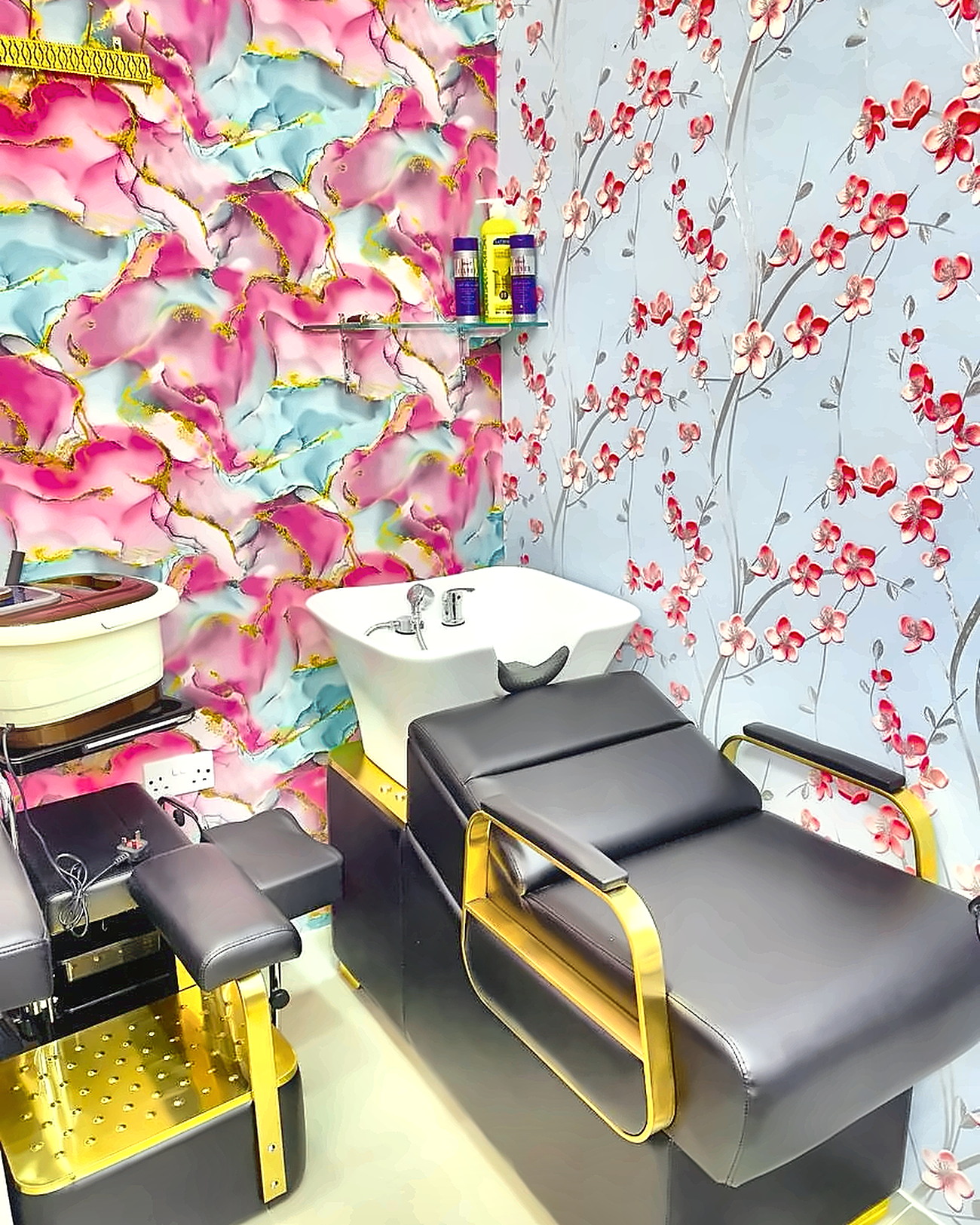 White backwash basin with a black-and-gold reclining chair and pedicure spa in the wash corner