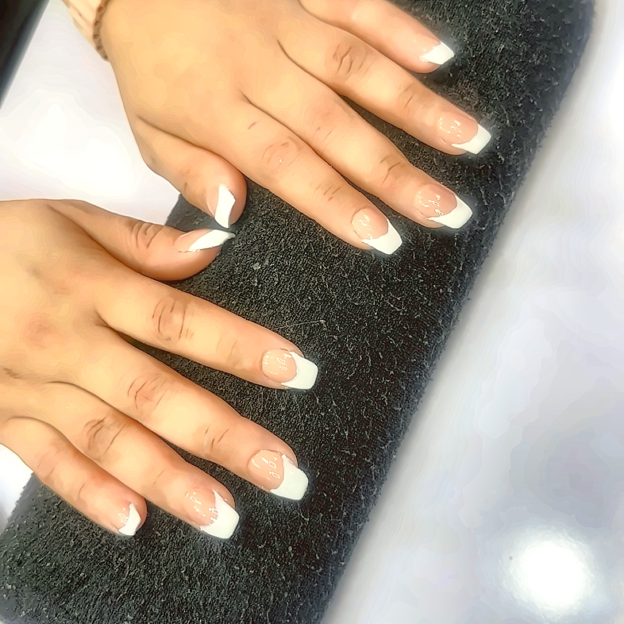 Long sculpted nail extensions shaped and buffed before colour