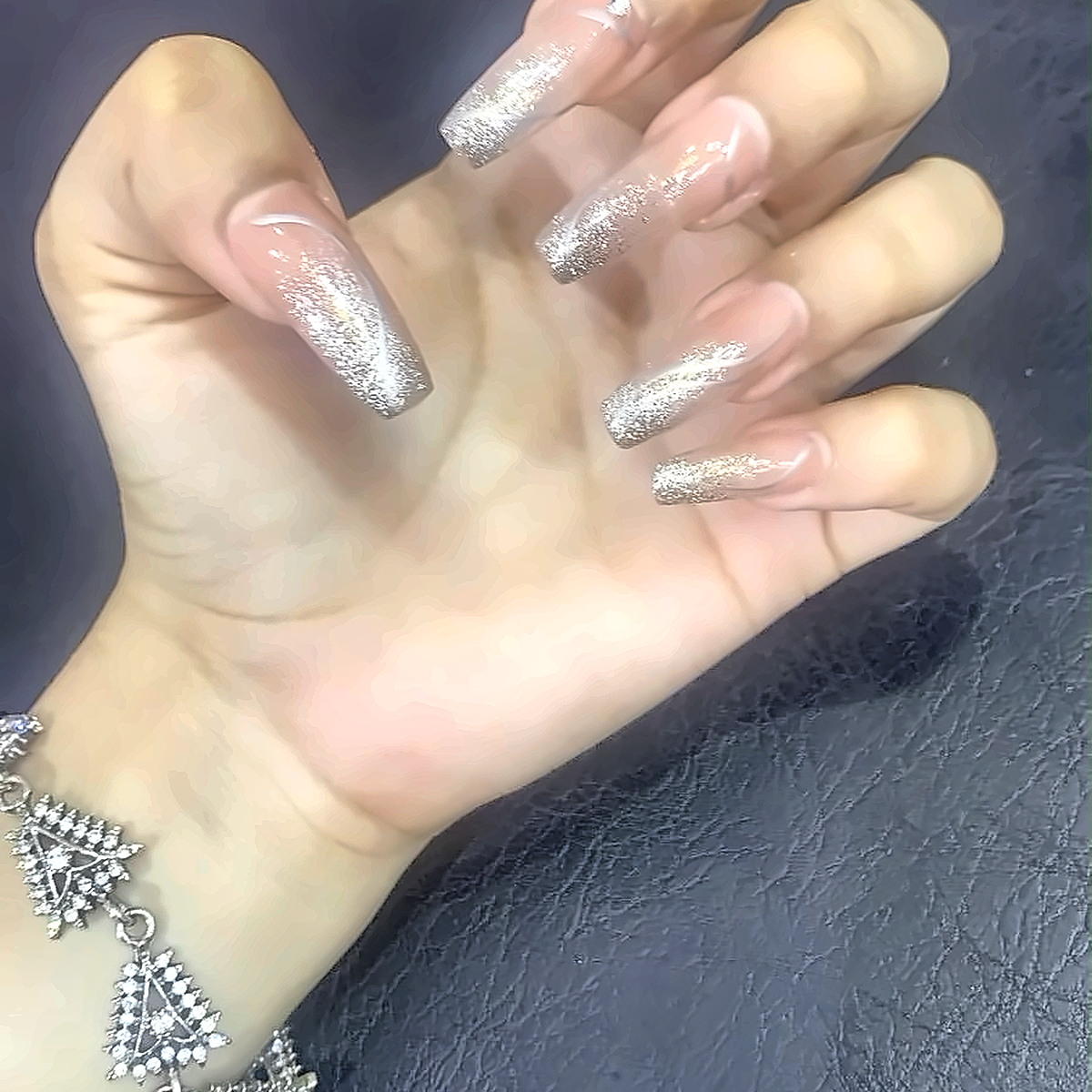 Gel nails finished with a sparkling glitter ombré fade