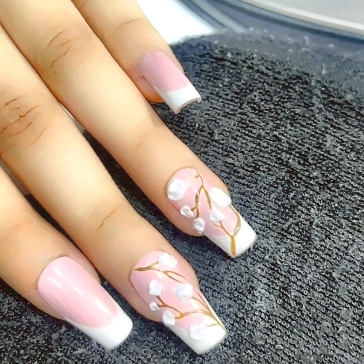 Long gel nails hand-painted with delicate floral nail art